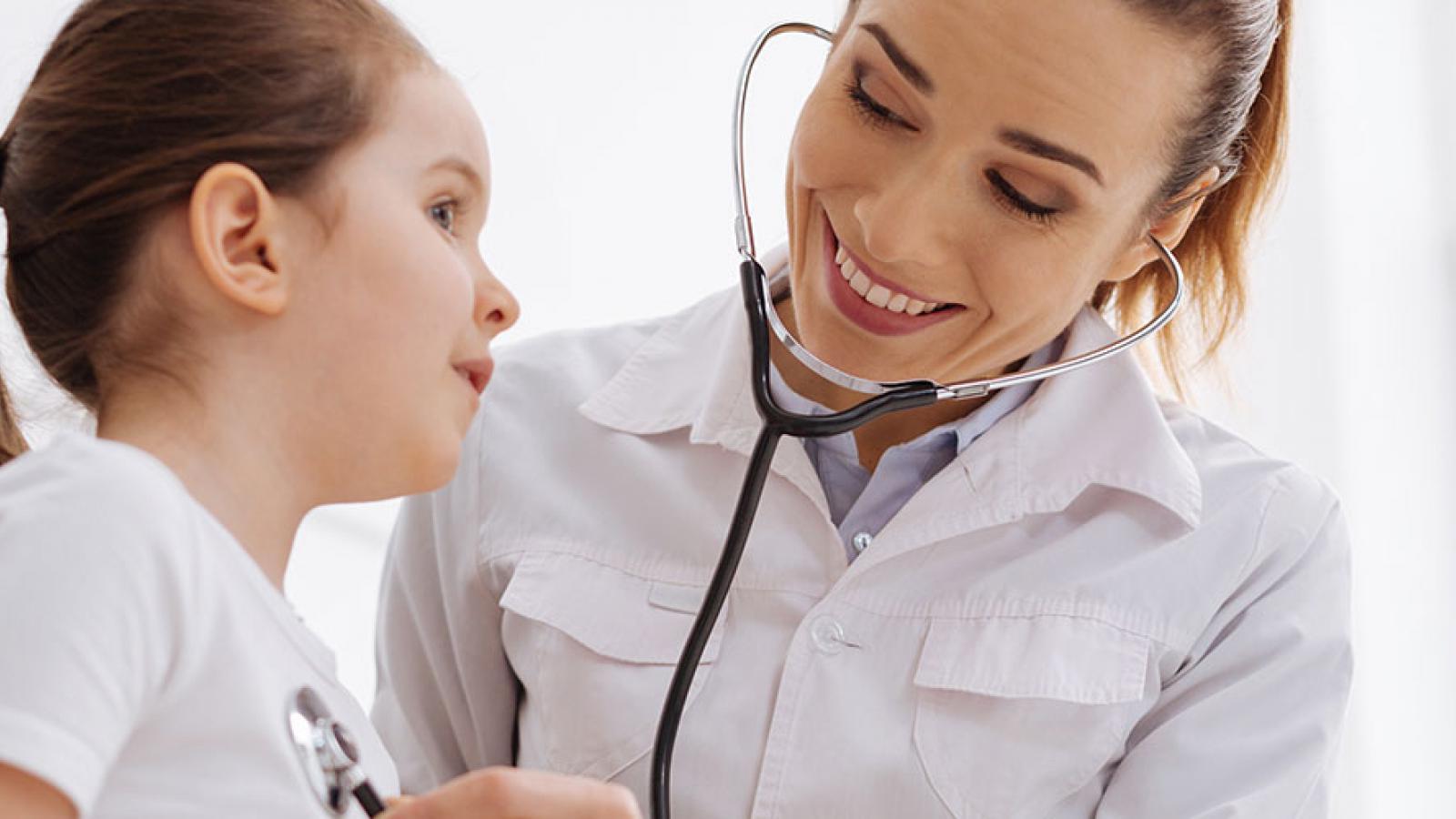 Doctor using stethoscope on child 